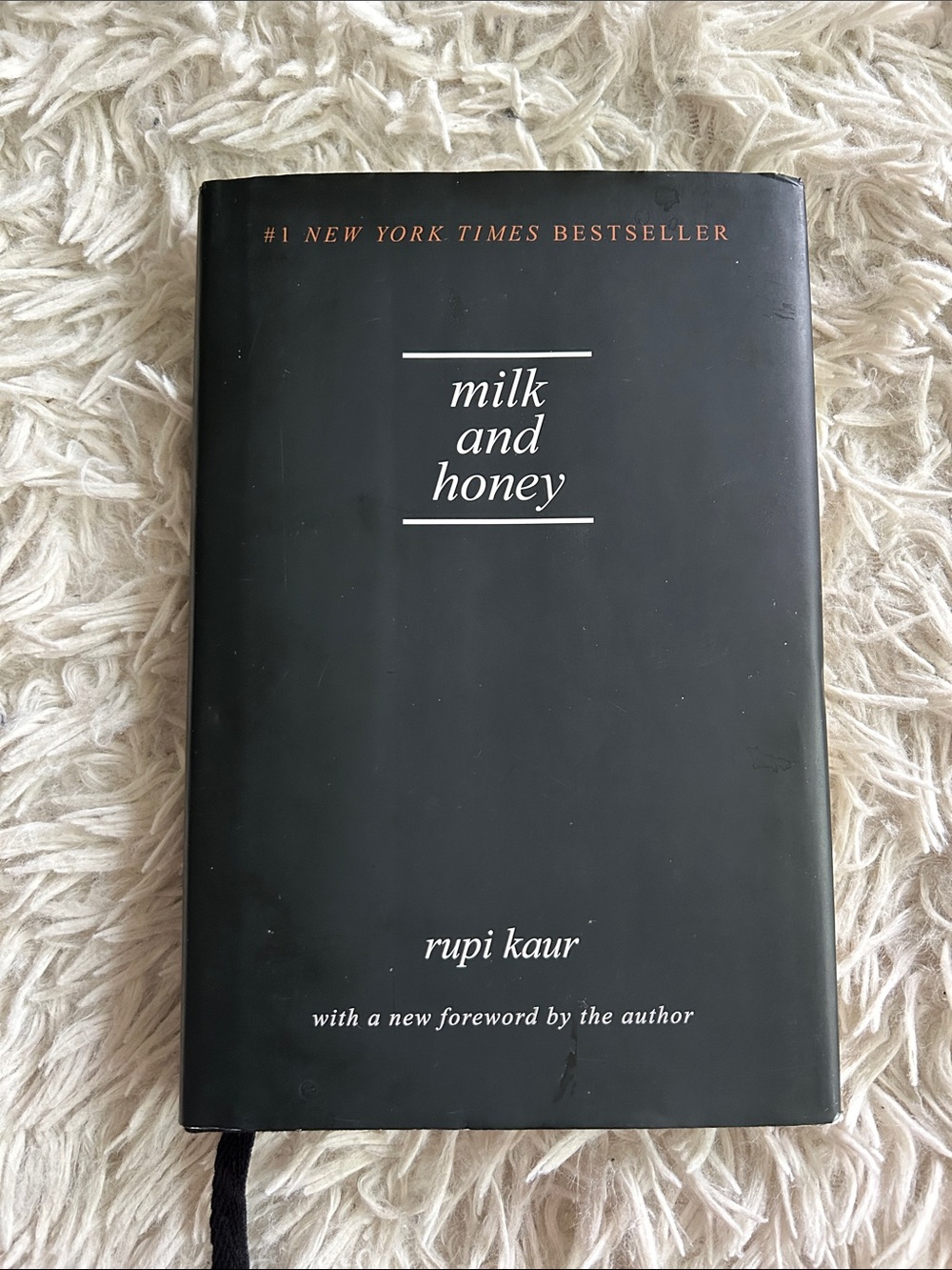 "milk and honey" Hardcover Book - Black by Rupi Kaur, poetry and illustrations